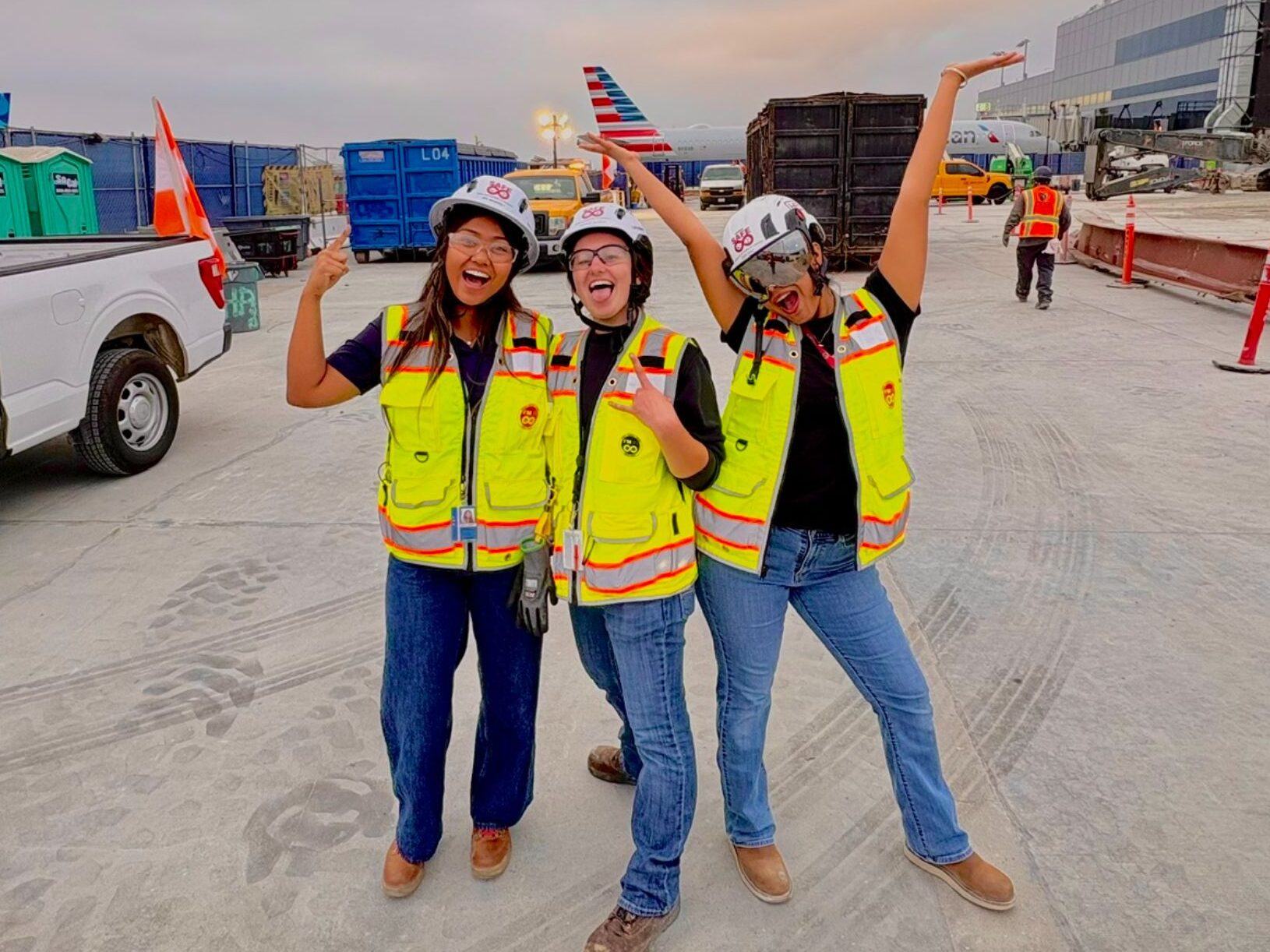 Hensel Phelps women employees posing for a fun group picture wearing their PPE on the jobsite. 