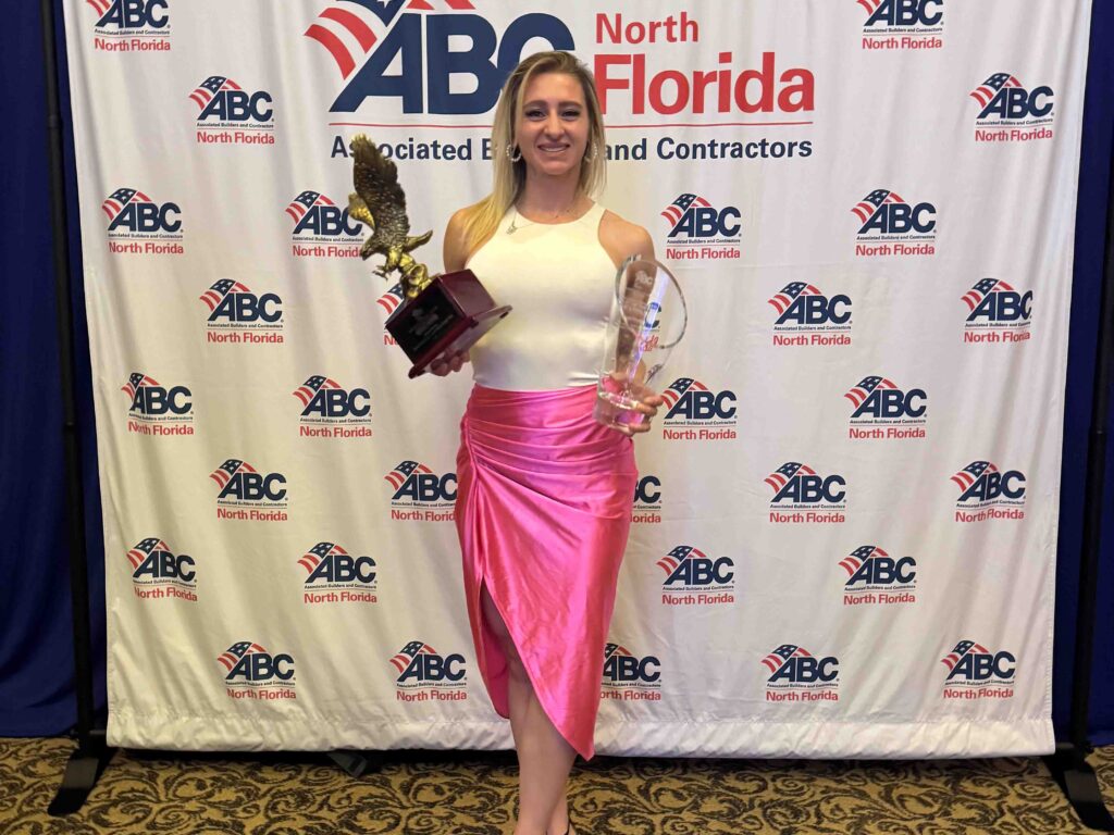 Picture of Hensel Phelps representative  at the awards ceremony accepting the award for the SOF Aircraft Maintenance Unit and Weapons Hangar Facility.