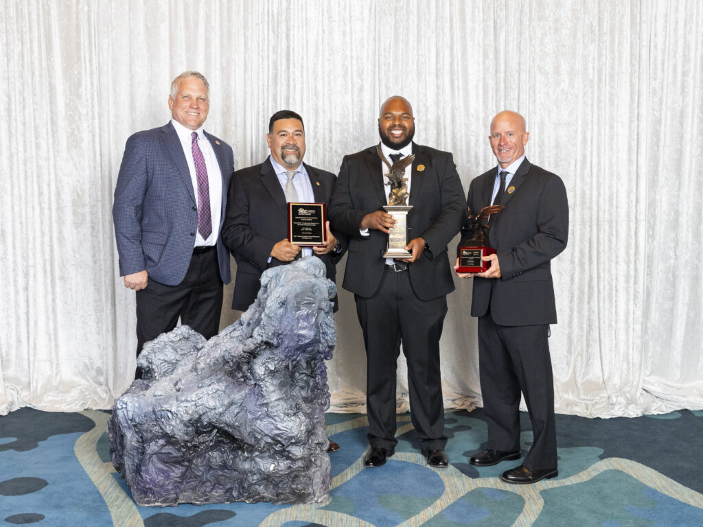 group picture of Hensel Phelps team accepting the project award for the How to Train Your Dragon - Isle of Berk.