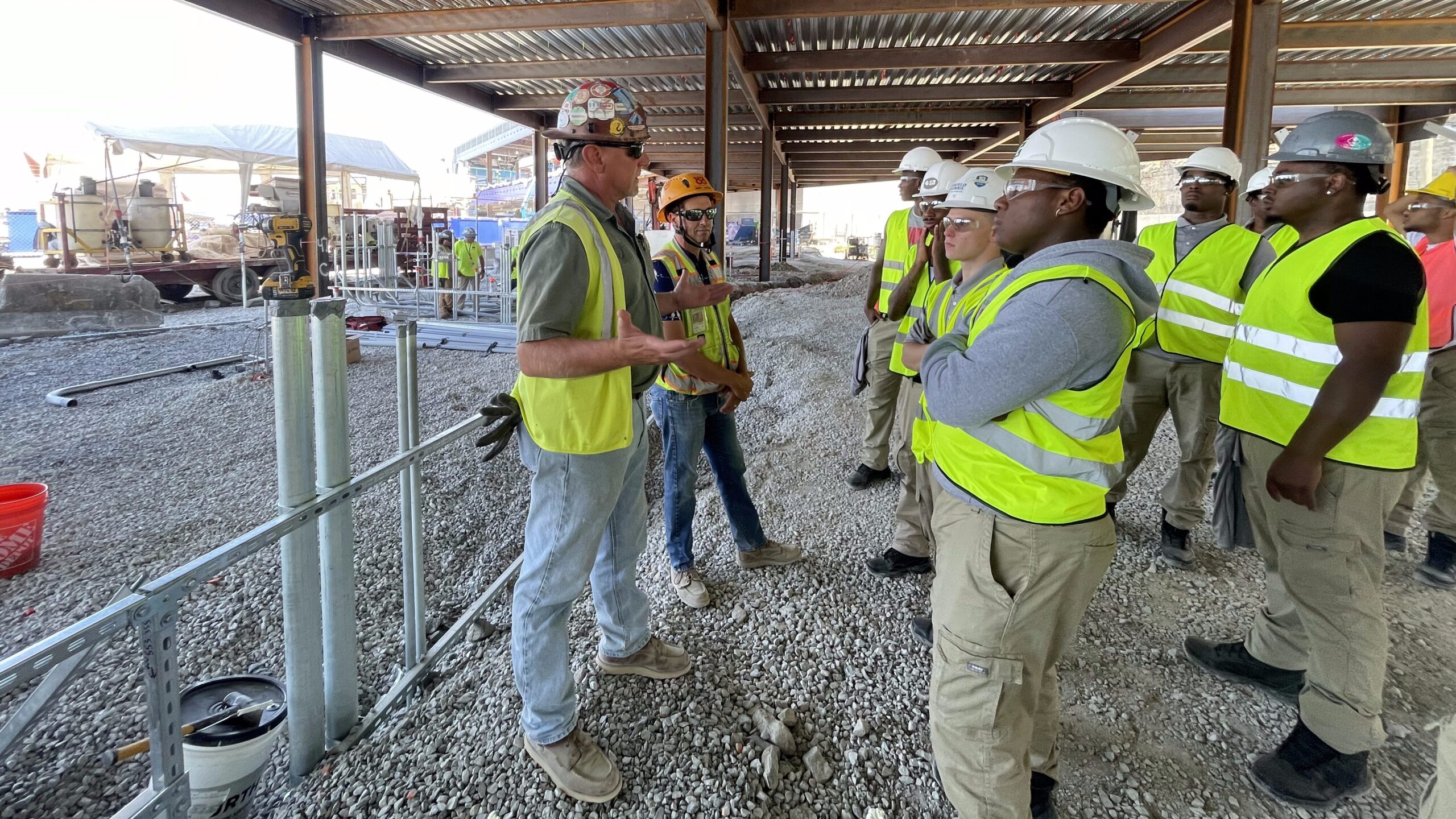 Hensel Phelps team members and project partners stand together at an active construction site.