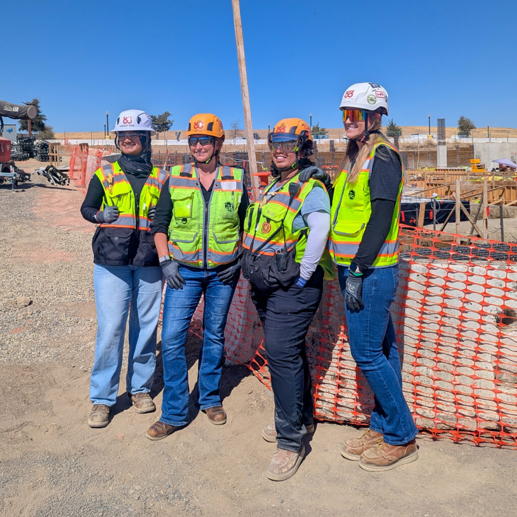 female construction workers pose for a magazine article