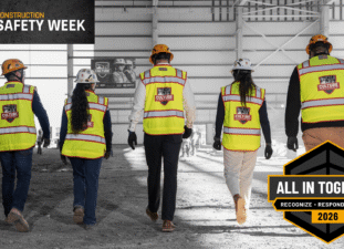 Hensel Phelps construction team walks in PPE with Construction Safety Week 2026 logos