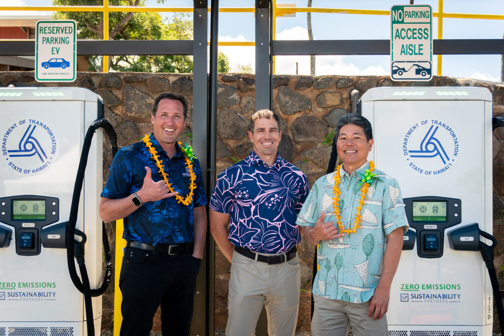 Project partners from Sustainability Partners, Hensel Phelps, and the State of Hawaii pose together during the ribbon-cutting ceremony for the new EV charging station at Kapalua Airport in Lahaina, Maui