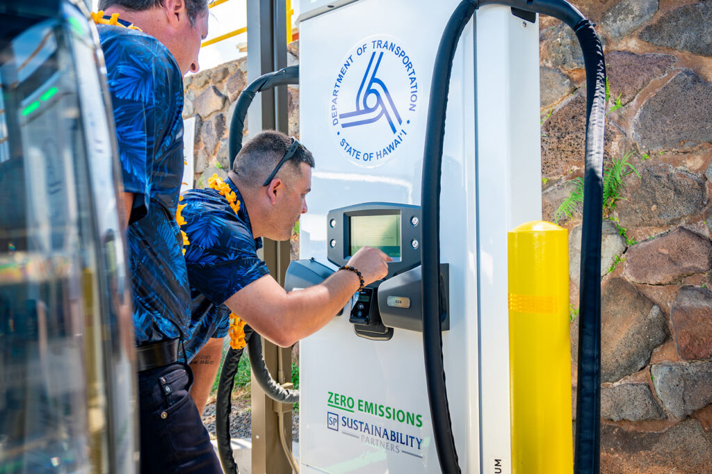Sustainability Partners representative reads meter on new EV charging station