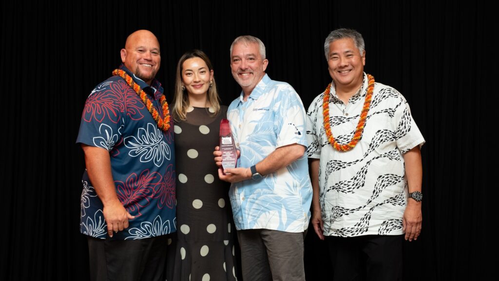 Three Hensel Phelps representatives pose with the Build Hawaii Award of Excellence for the 24-Inch Water Transmission Line Replacement project.