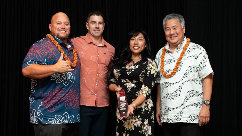 Three Hensel Phelps representatives pose with the Build Hawaii Award of Excellence for the Four Seasons Osteria Mozza Lanai and Front Entry Renovations project.