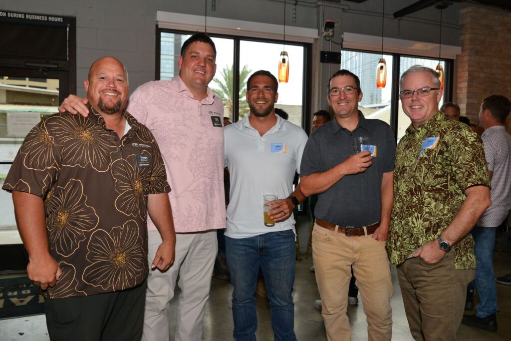 Guests enjoy food, refreshments, and conversation at a Partner Appreciation event in Hawaii.