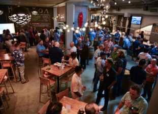 Owners. trade partners, project team members, and industry partners gather for a group photo during a Trade Partner Appreciation event in Hawaii.