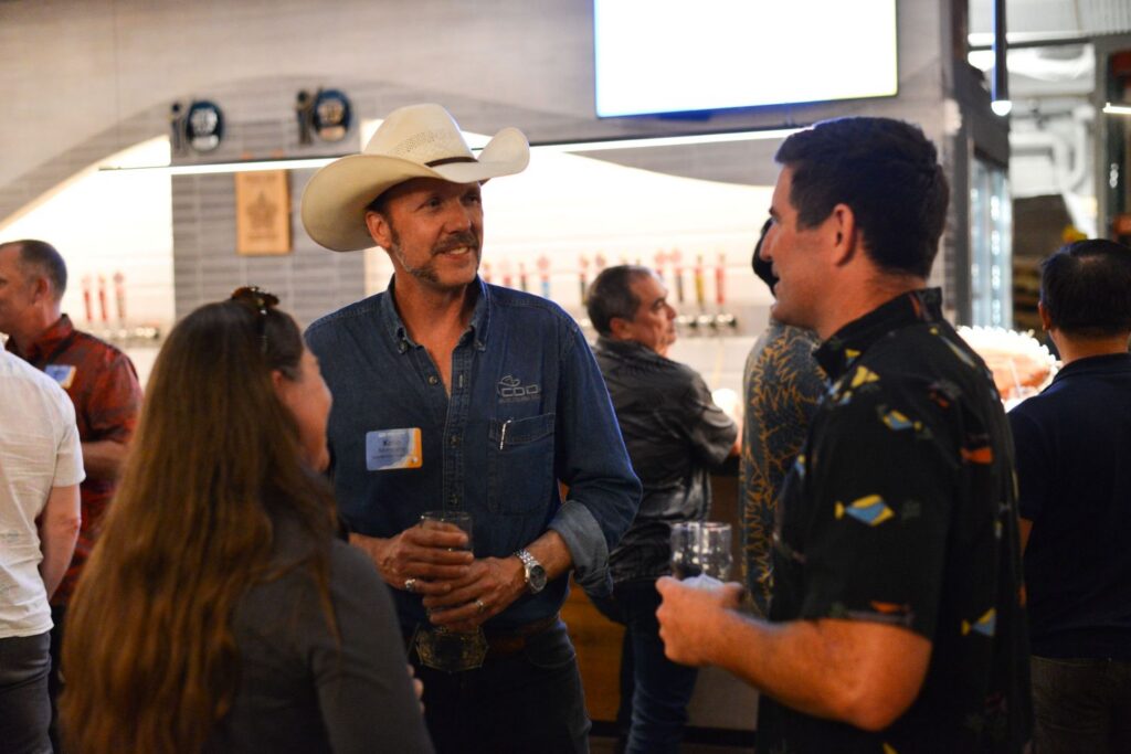 Guests enjoy food, refreshments, and conversation at a Partner Appreciation event in Hawaii.