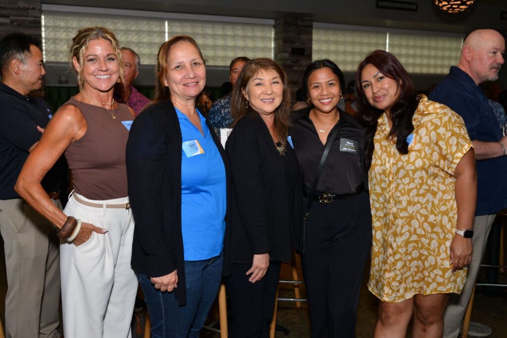 Guests enjoy food, refreshments, and conversation at a Partner Appreciation event in Hawaii.