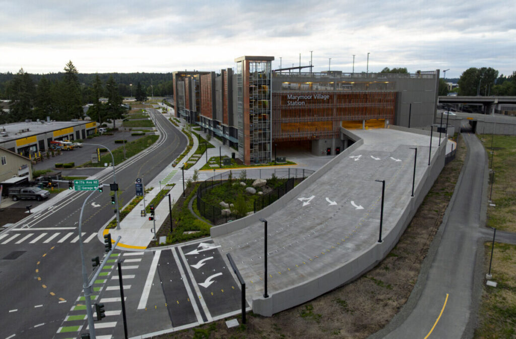 Marymoor Village Station with an entrance ramp, surrounding streets and pedestrian pathways under a cloudy sky.